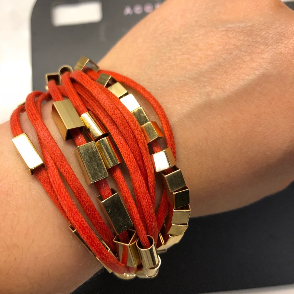 Boutique orange gold bracelet with moving pieces